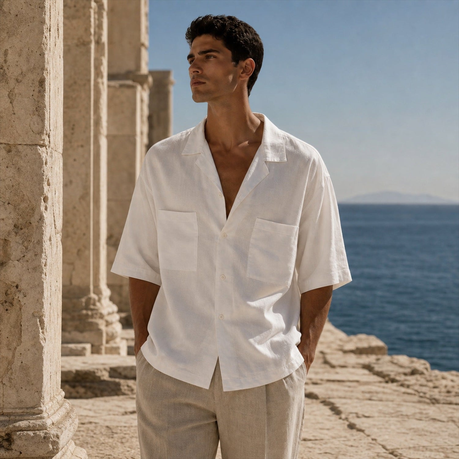 ZEUS model wearing a white linen shirt on the Greek coast